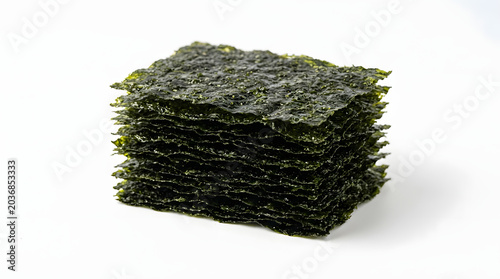 Stack of crisp dried Korean roasted seaweed sheets, isolated on a white background. Perfect for sushi or gimbap