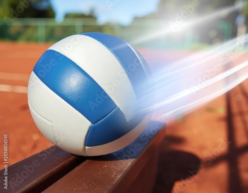Fast moving blue and white volleyball flying across a court.