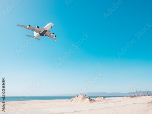 plane landing over the beach at lax in los angeles california