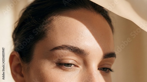 Natural glow on a woman forehead and eyebrows in sunlight