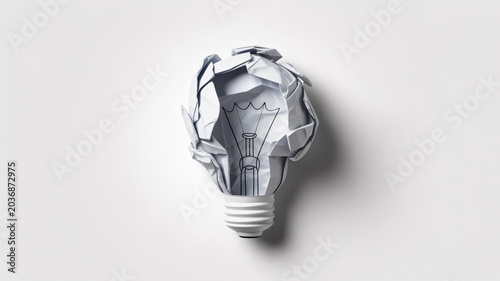 Crumpled paper light bulb symbolizing a failed or discarded idea concept