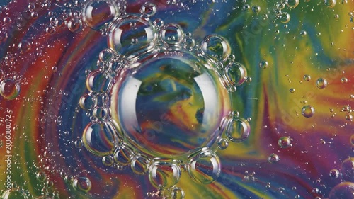 Closeup of Rainbow Bubbles Forming and Floating in Water.