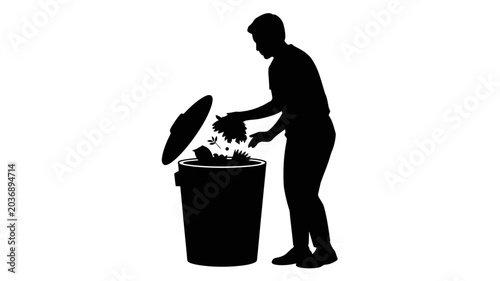 Man throwing grass into a trash can
