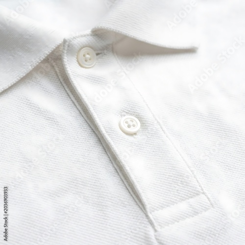 Close up of folded white linen napkin with embroidered monogram.
