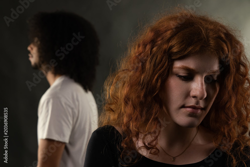 Billede på lærred Young couple turning backs, feeling sadness and separation in their relationship