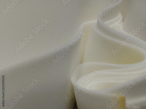 rolls of thin white sponge foam sheets.