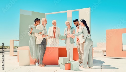 Diverse group collaborating creatively in a vibrant outdoor workspace.