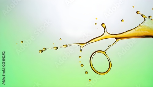 Dynamic Golden Oil Splash with Drops and Ring Shape on Green Background