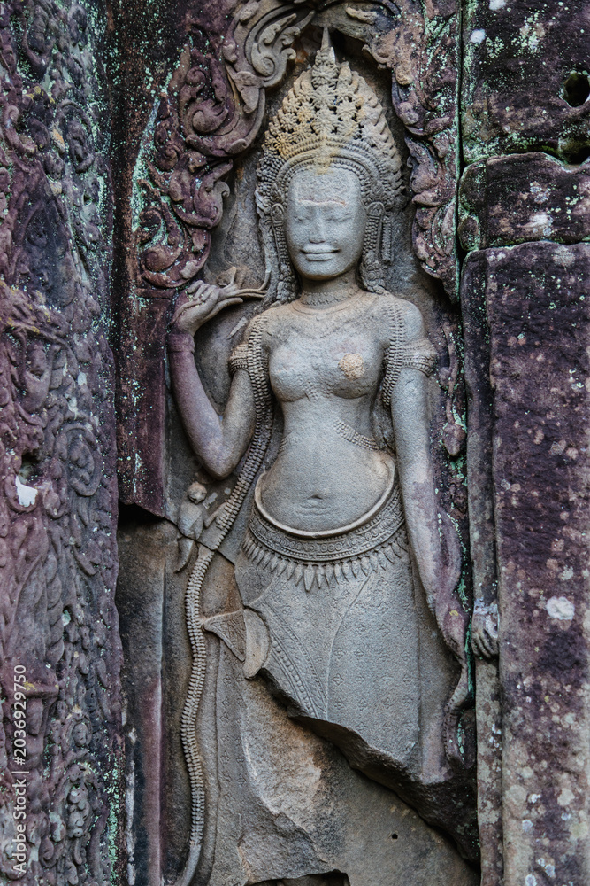Fototapeta premium Apsara dancer carved into stone at Angkor Wat, Bayon Temple, Siem Reap, Cambodia. These celestial dancers are a common motif in Khmer art and architecture.