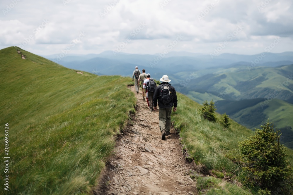 Fototapeta premium Group hiking a mountain ridge trail