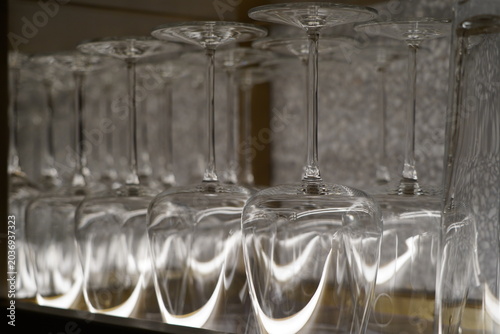 Rows of drinking glasses on a shelf in a restaurant