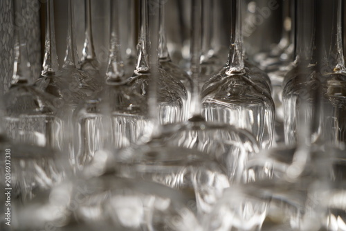 Rows of drinking glasses on a shelf in a restaurant