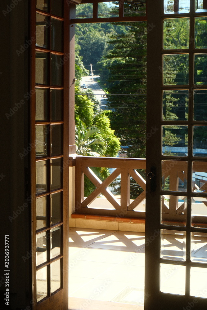 Fototapeta premium Tropical Morning Light Through Open French Doors