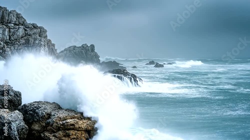 Stormy Waves Crashing on Rocky Coastline at Dusk