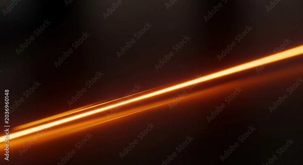 Fototapeta premium Abstract glowing orange light streak on dark background.