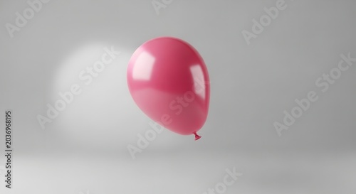 A single pink balloon floats in a bright, minimalist studio setting with soft lighting.