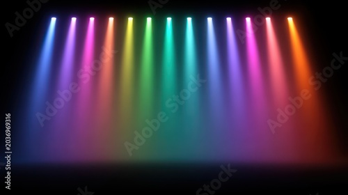 Colorful stage lights illuminate a dark space, creating an energetic atmosphere.
