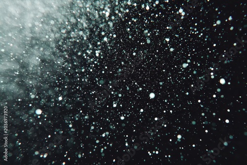 Abstract close-up of sparkling water droplets against a dark background.