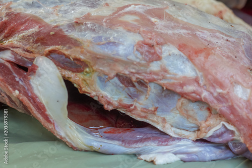 Картината върху платно a freshly slaughtered animal carcass showing detailed layers of raw red meat, white fat, and inner muscle tissue