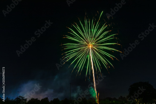 Fireworks with dark sky background. Green, red, and white. Independence Day celebration, Santa Clarita, California. 
