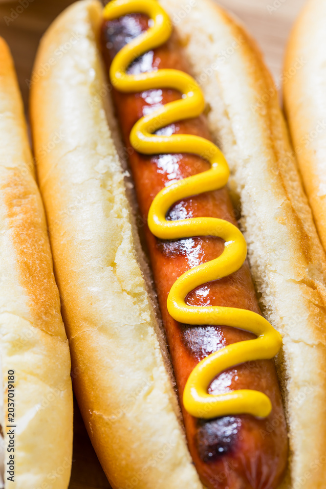 Obraz premium Gourmet Grilled Hot Dogs with Mustard and Relish