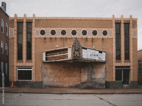 фотографія Front view of the abandoned historic Art Deco Massac Theatre building with a boa