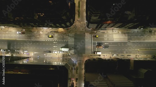 City streets at night with moving cars and empty buildings