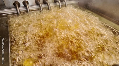 Cooking noodles in boiling oil for crispy texture