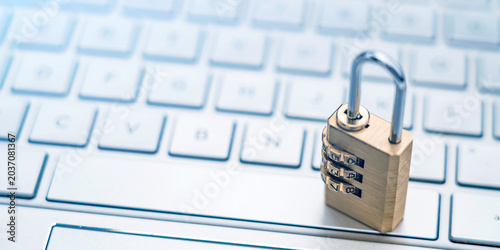 The lock is placed on the computer keyboard to symbolize information security and data interconnection