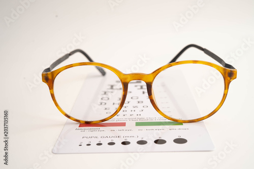 Obraz na płótnie Glasses on eye testing exam chart to check eyesight accuracy of reading
