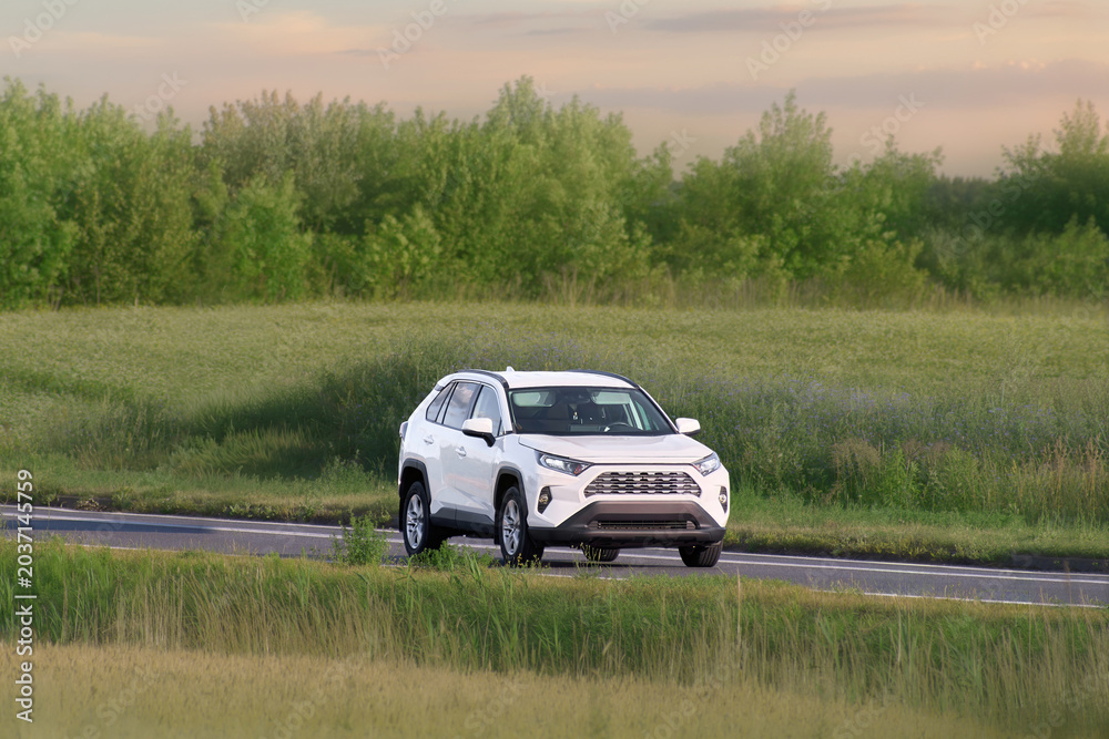 Fototapeta premium Popular Japanese SUV driving through daily traffic