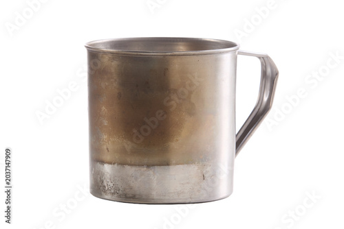 Metal mug shows aged patina and sturdy handle