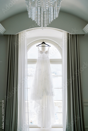 Fotografija Serene wedding gown in window