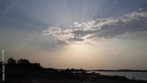 Dramatic sunset sky with sunbeams over reservoir video