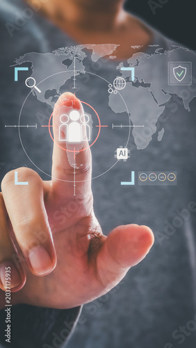 A hand touches a virtual holographic interface showing a world map with a red target over user icons, illustrating global audience targeting and AI tech.