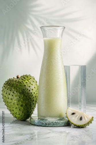 Soursop juice carafe with whole fruit and sliced tropical garnish