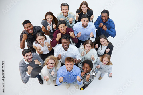 large group looking up with fists clenched