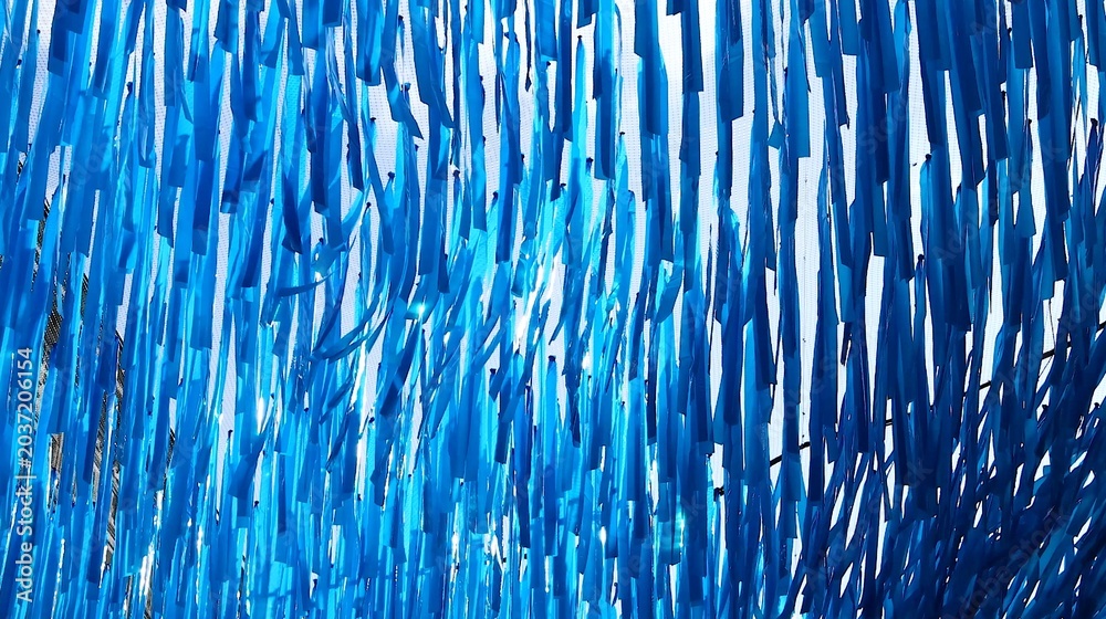 Obraz premium Vibrant Blue Streamers Hanging in a Dense Vertical Pattern