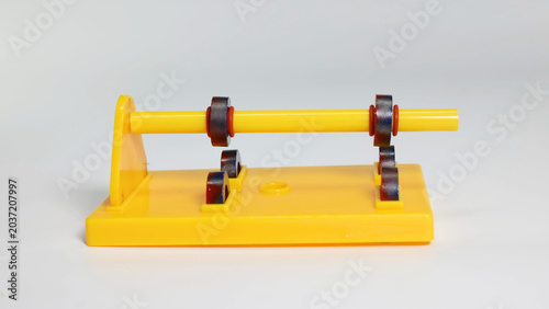 Schilderij op canvas Magnetic Force Physics Demonstration Tool on Yellow Plastic Stand
