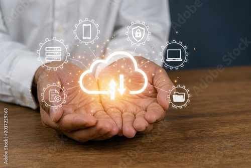 Hands holding a glowing cloud icon with download and upload arrows surrounded by circular technology symbols representing cloud computing and data transfer.