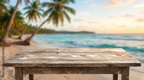 Wooden table mockup with tropical beach and ocean background