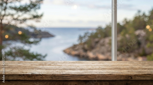 Wooden table mockup with blurred coastal landscape background