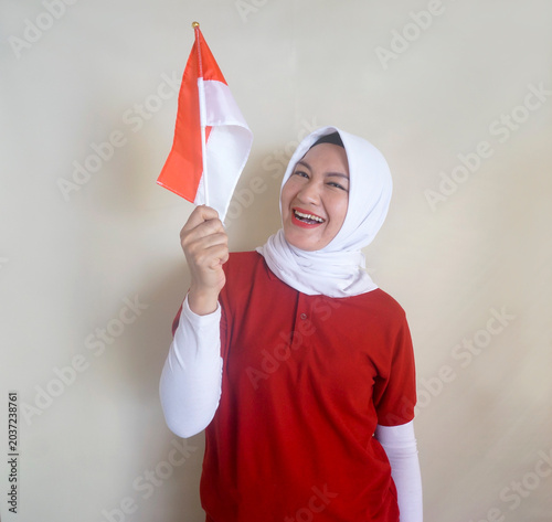 Young Woman Holding Indonesian Flag To Support National Team Soccer On Match. Sports, Fans And Independence Day Concept
