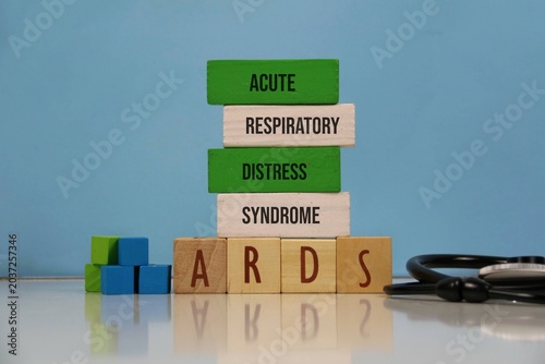 Acute Respiratory Distress Syndrome (ARDS) Concept With Wooden Blocks And Stethoscope On blue Background