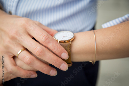 Businesswoman wearing wrist watch, close-up