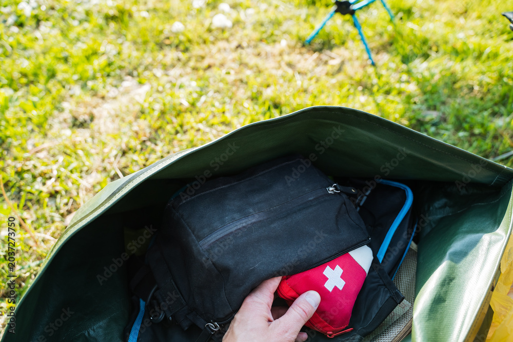 Fotografie Packing medical kit into backpack
