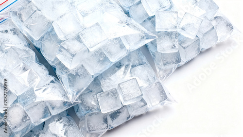 Top view of multiple clear plastic bags full of ice cubes isolated on white background copy space.