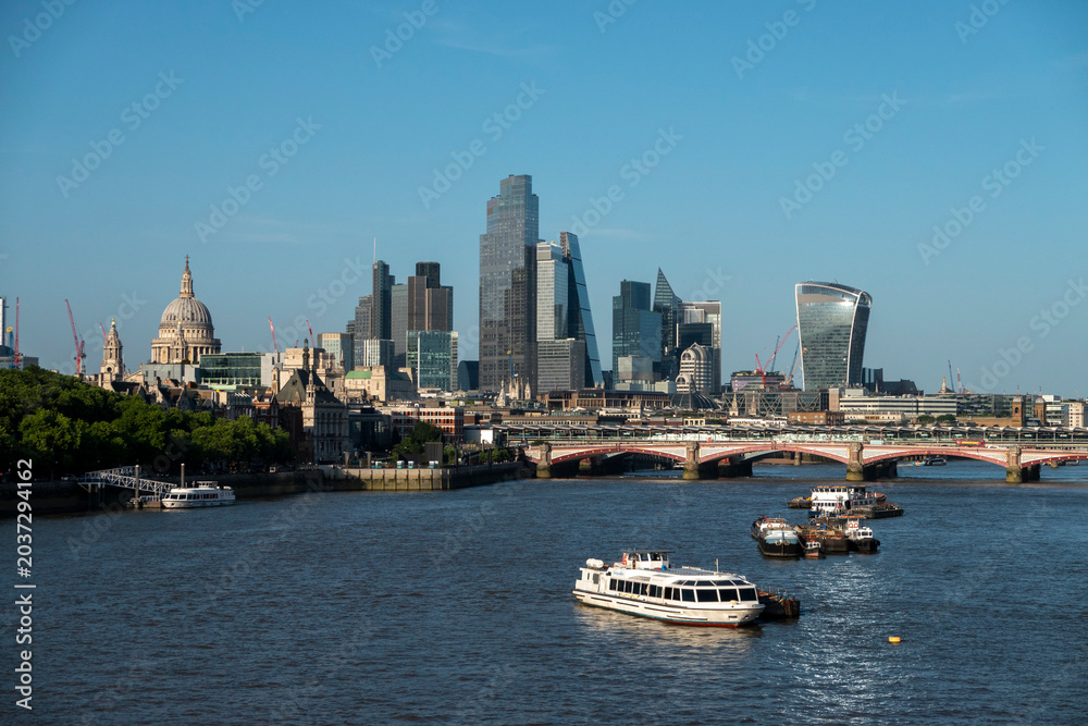 Obraz premium London, UK, 27th May 2026 - London Skyline from Waterloo bridge showing building work in progress and the main financial district, late evening suchine, tight shot with details of buildings