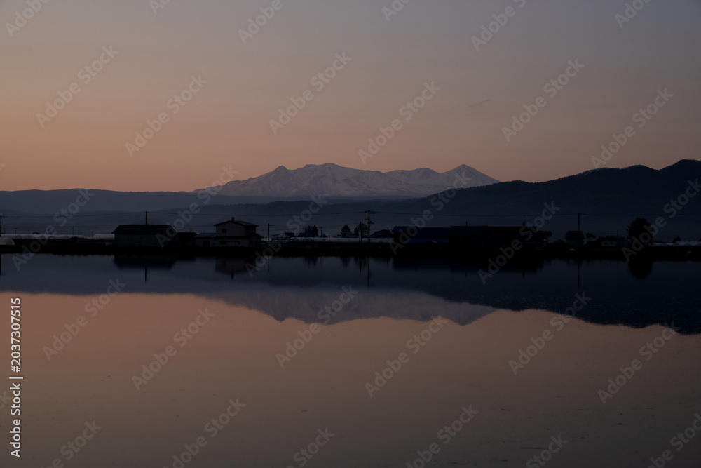 Fototapeta premium Hokkaido, snowy mountain and mountain ridges, with rural landscape, in spring, landscape
