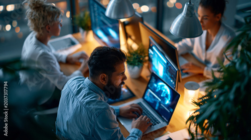 A  AI startup team viewed from above develops softly bright software in a calm modern office analyzing system performance during QA testing in soft daylight startup